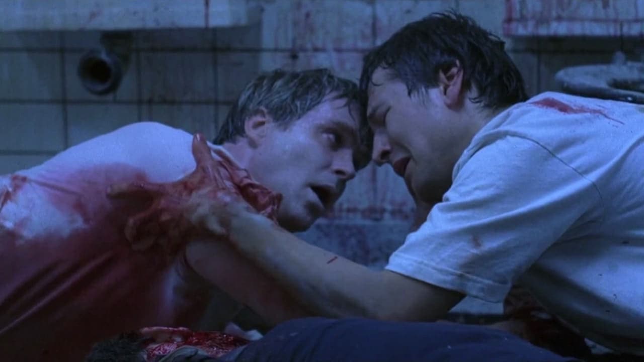 Adam e o Dr. Gordon acorrentados no banheiro em Jogos Mortais (2004)